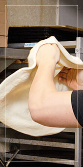 renzo's pizza man stretching out pizza dough
